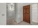 Inviting home foyer featuring neutral colors and a solid wood door at 9123 W Utopia Rd, Peoria, AZ 85382