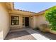 Exterior front door, with a small window, and surrounded by desert landscaping at 9123 W Utopia Rd, Peoria, AZ 85382