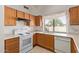Updated kitchen featuring white appliances and oak cabinets at 9123 W Utopia Rd, Peoria, AZ 85382