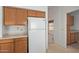 Bright eat-in kitchen with white fridge and oak cabinets at 9123 W Utopia Rd, Peoria, AZ 85382