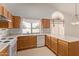 Well-lit kitchen with oak cabinets and white appliances at 9123 W Utopia Rd, Peoria, AZ 85382