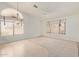 Spacious living room with vaulted ceiling, neutral colors, and bright windows at 9123 W Utopia Rd, Peoria, AZ 85382
