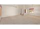 Spacious living room featuring neutral carpet, white walls, and ample natural light at 9123 W Utopia Rd, Peoria, AZ 85382
