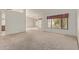 Spacious carpeted living room featuring ample natural light and neutral decor at 9123 W Utopia Rd, Peoria, AZ 85382