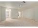 Spacious main bedroom with ceiling fan and view of main bath and closet at 9123 W Utopia Rd, Peoria, AZ 85382