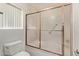 Bathroom shower with a sliding glass door and toilet at 9123 W Utopia Rd, Peoria, AZ 85382