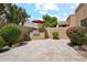 Paver patio features a built in grill, beautiful landscaping and an umbrella covered seating area at 9460 N 105Th Pl, Scottsdale, AZ 85258
