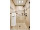 Modern bathroom featuring a glass-enclosed shower, rain shower head, and tiled walls at 9460 N 105Th Pl, Scottsdale, AZ 85258