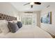 Comfortable bedroom featuring a large bed, neutral decor, and a window that brings in natural light at 9460 N 105Th Pl, Scottsdale, AZ 85258