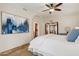 Well-lit bedroom with a ceiling fan, an ensuite bath and walk-in closet offering ample storage space at 9460 N 105Th Pl, Scottsdale, AZ 85258