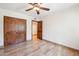 Large bedroom featuring a ceiling fan, tile floors, and a sliding wood-door closet at 9460 N 105Th Pl, Scottsdale, AZ 85258