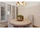 Bright breakfast nook with cozy seating and view of the backyard through shuttered windows at 9460 N 105Th Pl, Scottsdale, AZ 85258