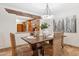 Elegant dining room with stylish lighting, seating for four, and open access to the kitchen at 9460 N 105Th Pl, Scottsdale, AZ 85258