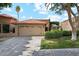 Charming single-story home features a terracotta roof, mature landscaping, and a two-car garage at 9460 N 105Th Pl, Scottsdale, AZ 85258