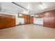 Well-lit garage with epoxy floors and ample storage cabinets along the walls at 9460 N 105Th Pl, Scottsdale, AZ 85258