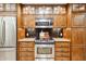 Close up on a chef's kitchen boasting stainless steel appliances and custom wood cabinets at 9460 N 105Th Pl, Scottsdale, AZ 85258