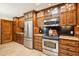Chef's kitchen boasts stainless steel appliances, custom wood cabinets, and granite countertops at 9460 N 105Th Pl, Scottsdale, AZ 85258