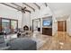 Spacious living room with high ceilings, exposed beams, cozy fireplace, and seamless indoor-outdoor living at 9460 N 105Th Pl, Scottsdale, AZ 85258