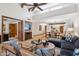 Spacious living room featuring high ceilings, wood beams, tile flooring, and comfortable seating at 9460 N 105Th Pl, Scottsdale, AZ 85258