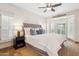 Serene main bedroom with plush carpeting, bay windows, and a ceiling fan at 9460 N 105Th Pl, Scottsdale, AZ 85258