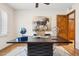 Home office with a large desk, decorative elements, and a window that offers natural light at 9460 N 105Th Pl, Scottsdale, AZ 85258