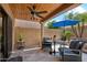Covered patio features ceiling fan, accent pillars, and view of the home's outdoor landscaping at 9460 N 105Th Pl, Scottsdale, AZ 85258
