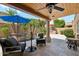 Cozy covered patio features a stone fountain, ample seating, and a built in gas grill at 9460 N 105Th Pl, Scottsdale, AZ 85258