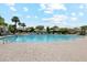 Community pool surrounded by mature shade trees and ample seating at 9460 N 105Th Pl, Scottsdale, AZ 85258