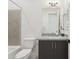 Cozy bathroom with granite countertop vanity, toilet, mirror, and shower-tub combo with tiled surround at 1 Easy St # 15, Carefree, AZ 85377