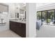 Elegant bathroom featuring double sinks, granite countertops, and a view into the connected bedroom and balcony at 1 Easy St # 15, Carefree, AZ 85377