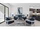 Beautifully staged living room with blue sofa, modern art, and a view into the open kitchen area at 1 Easy St # 15, Carefree, AZ 85377