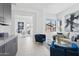 Bright living room with blue accents, comfortable seating, and a glimpse into the adjacent office space at 1 Easy St # 15, Carefree, AZ 85377