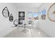 Bright office space with a glass desk, modern decor, and a window offering natural light at 1 Easy St # 15, Carefree, AZ 85377