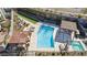 Aerial view of a pool area with lounge chairs, bocce court, covered seating and spa at 1 Easy St # 15, Carefree, AZ 85377
