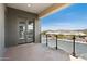A modern balcony with glass railings and a view of the parking area and mountains at 1 Easy St # 4, Carefree, AZ 85377