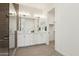 Bathroom features a double sink vanity, large mirror, and walk-in shower with tile surround at 1 Easy St # 4, Carefree, AZ 85377