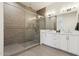Well-lit bathroom with tile floors, glass-enclosed shower, and a double sink vanity with white marble countertop at 1 Easy St # 4, Carefree, AZ 85377