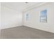 Bright, airy bedroom featuring neutral walls, gray carpet, and natural light from two windows at 1 Easy St # 4, Carefree, AZ 85377