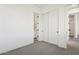 A bedroom with carpet and access to a bathroom and a closet at 1 Easy St # 4, Carefree, AZ 85377