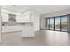 Modern kitchen with white cabinets, stainless steel appliances, and large sliding doors to the backyard at 1 Easy St # 4, Carefree, AZ 85377