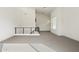 Expansive loft area with neutral carpet, high ceilings, and modern black metal stair railing at 1 Easy St # 4, Carefree, AZ 85377