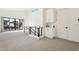 Carpeted loft area with modern railing, beverage bar, sliding glass door, and lots of light at 1 Easy St # 4, Carefree, AZ 85377