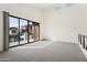 Bright loft featuring modern railings, plush carpet, and sliding glass doors to a balcony at 1 Easy St # 4, Carefree, AZ 85377
