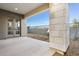 A backyard patio with a low maintenance landscape, stone exterior accents, and glass paneled doors at 1 Easy St # 4, Carefree, AZ 85377
