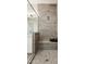 Close-up of a modern shower with a built-in bench, rainfall shower head, and neutral tiling at 1 Easy St # 4, Carefree, AZ 85377