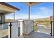 Balcony view with glass railing overlooks the parking area and distant mountains under clear skies at 1 Easy St # 5, Carefree, AZ 85377