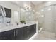 Beautiful bathroom featuring a double vanity, elegant tile, and a glass-enclosed shower at 1 Easy St # 5, Carefree, AZ 85377