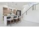 Modern kitchen with stainless steel appliances, quartz countertops, bar seating, and a staircase nearby at 1 Easy St # 5, Carefree, AZ 85377