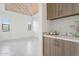 Bright living room with tile floors, wood plank ceiling, and small coffee bar with gray and white counters at 1 Easy St # 5, Carefree, AZ 85377