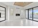 Bright living room with a fireplace, tile floors, wood ceiling feature, and sliding glass doors to a patio at 1 Easy St # 5, Carefree, AZ 85377